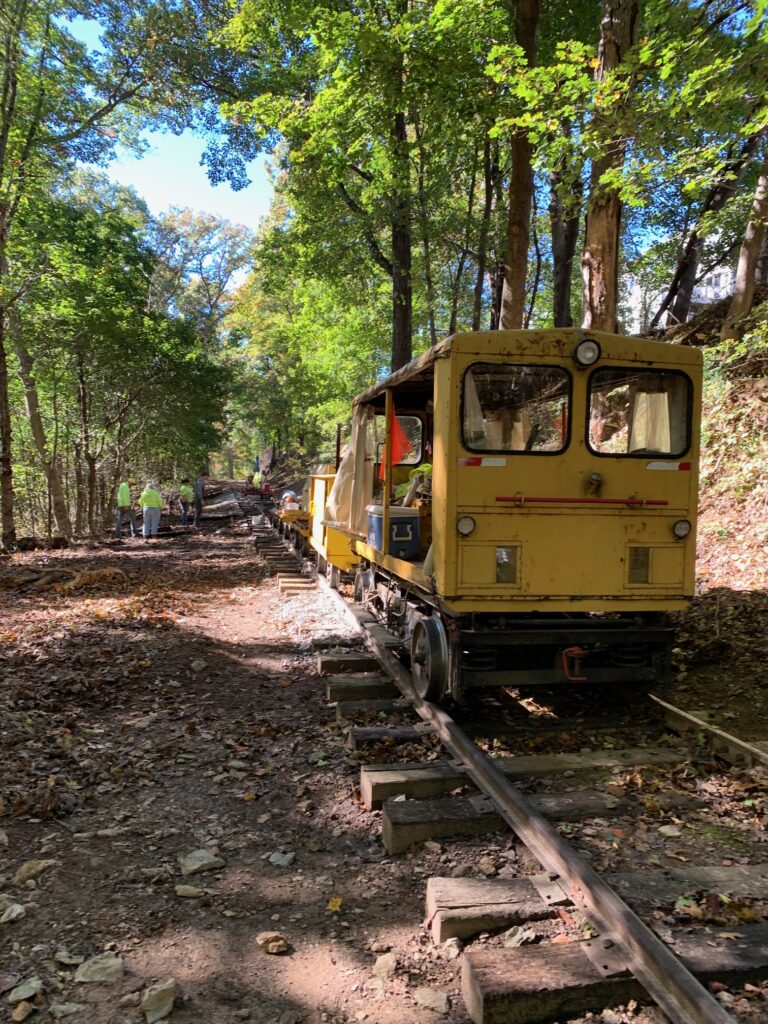 Motorcar and work train in the woods during tie replacement